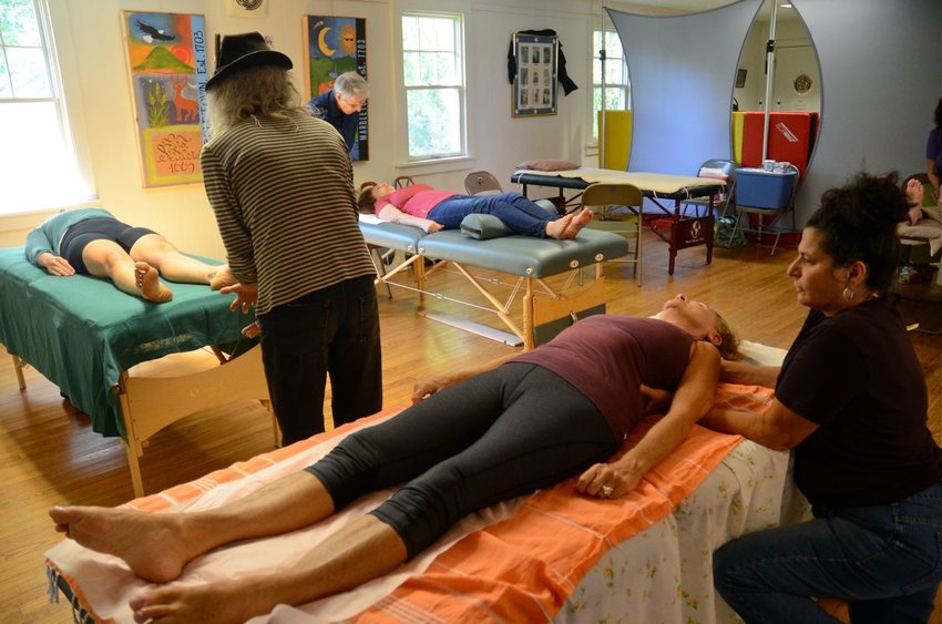 Practitioners are looking forward to meeting clients in person again, but many treatment modalities can be delivered via phone or Zoom. (Treatments at Community Health Care&nbsp;Day: Front to back: Jesse Scerer gives a massage, Rob Norris practices Reconnective Healing, and Mark Jordan, Energetic Chiropractic.)