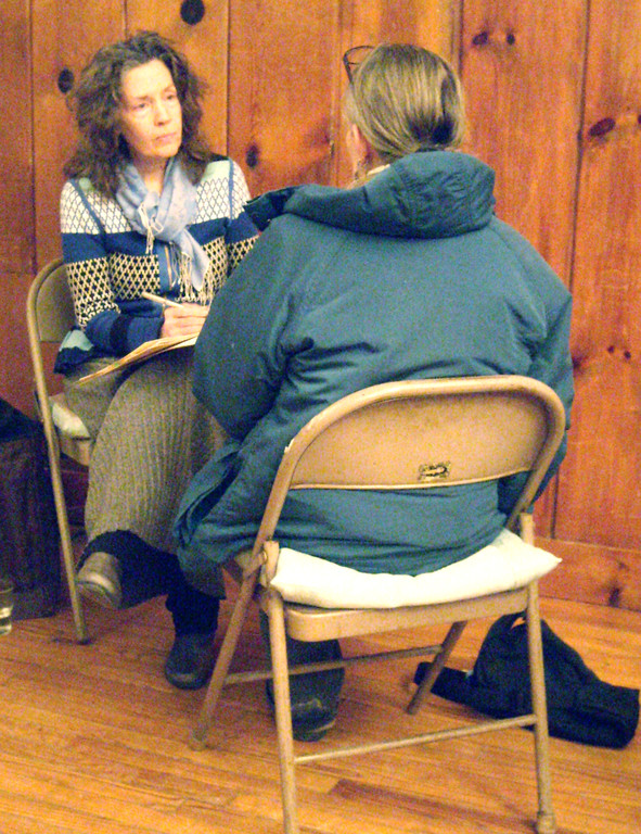 Practitioner Katy Bray speaks with a patient. Volunteers skilled in lesser-known health modalities such as Integral Homeopathics (pictured above), Soul Listening, and Plant Spirit Healing offer participants the chance to experience new holistic therapies.