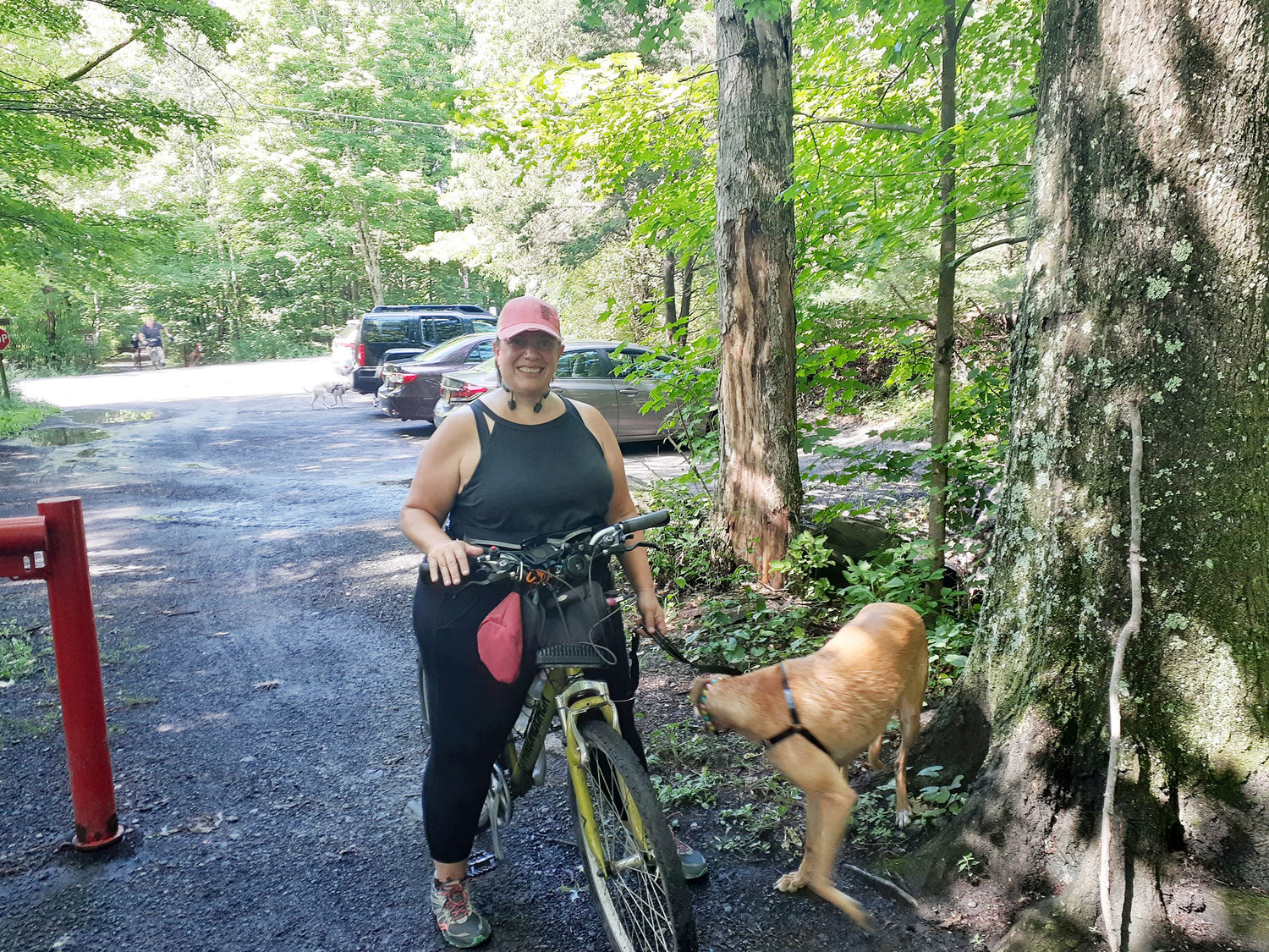 Lisa McGovern and Rocket at the Marcotte Road trailhead. Special posted rules include, stay 6' away, keep to the right, do not block trail, pass on the left and try not to touch surfaces.