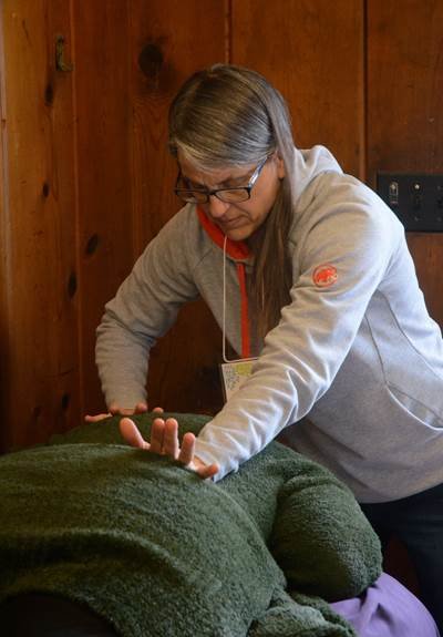 Practitioners are looking forward to meeting clients in person again, but many treatment modalities can be delivered via phone or Zoom. (Jesse Scerer gives
a massage)
