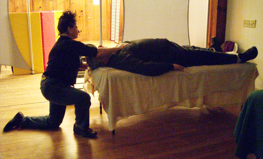 Jesse Scherer practices massage on a patient during Rondout Valley Holistic Health Community's January event.