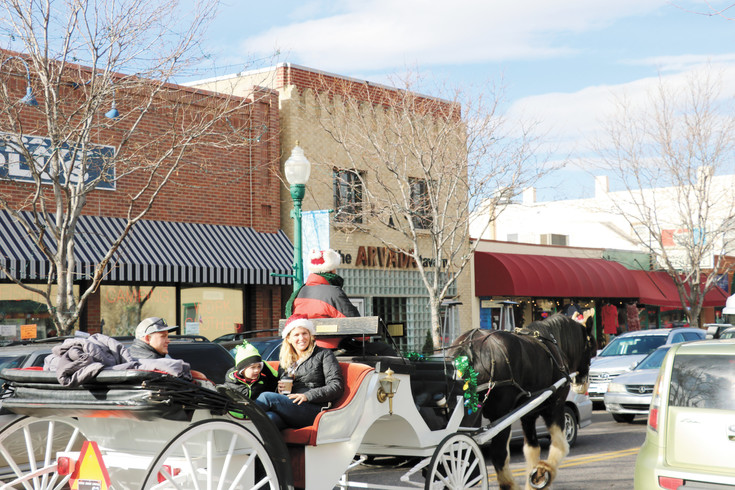 Arvada residents get an old carriage ride around Olde Town during the first of three Saturdays with Santa on Dec. 3.