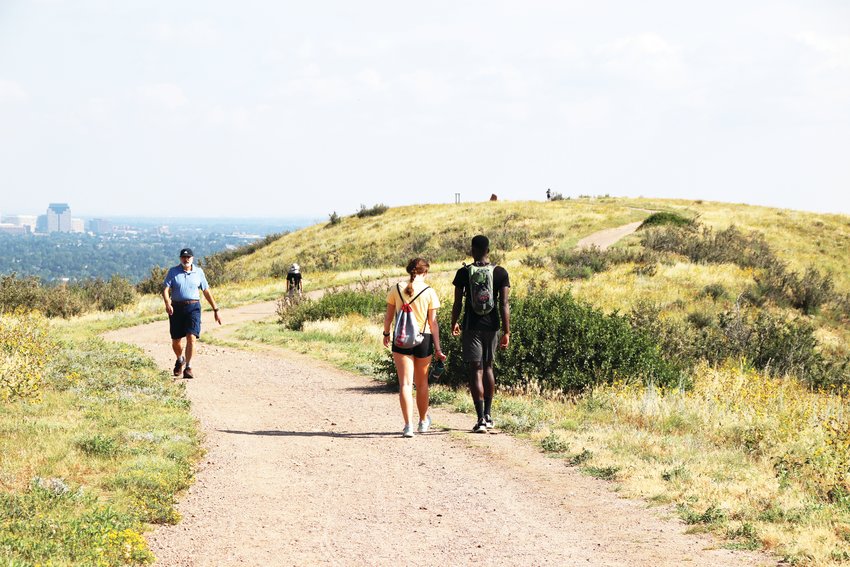 People hike at The Bluffs near Lone Tree, a popular metro area trail and park.
