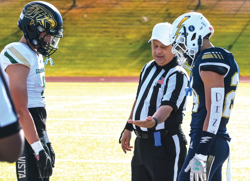 Referee Bob Pace of Colorado Springs conducts the coin toss before a 5A playoff game between Mountain Vista and Legacy at Five Star North Stadium in 2021.