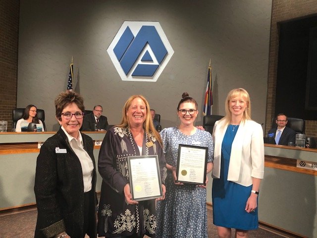 Arvada City Councilmember Lauren Simpson presents a proclamation from council recognizing April as Child Abuse Prevention Month to Court Appointed Special Advocates.