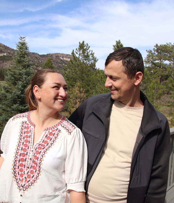 Maryna and Oleksandr Sheveria smile at each other on their new porch in Larkspur.