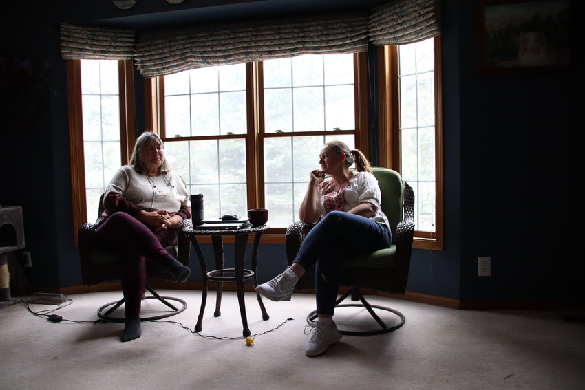 Helen Kellogg and Maryna Sheveria sit in the living room in Kellogg's Larkspur home.