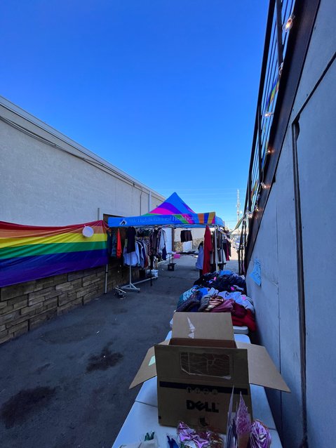 A rainbow flag decorated the wall as people approached the colorful tent at Transgender Center of the Rockies on June 15, 2022.