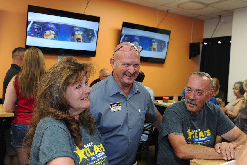 Adams County Democratic Sheriff candidate Gene Claps (center) visits with a pair of supporters during a campaign watch party at Frolic Brewing Company in Westminster on Primary Election Night, Tuesday, June 28. Claps defeated incumbent Sheriff Rick Reigenborn and will face former Sheriff Mike McIntosh in the General Election this fall.
