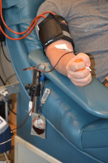 Brent Millspaugh donating blood on July 1, 2022, in the Vitalant bloodmobile.