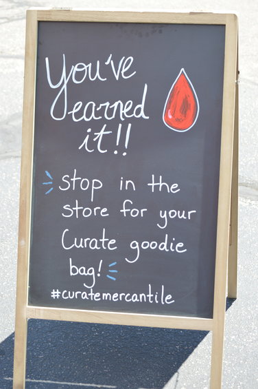 A sign placed outside the Vitalant bloodmobile on July 1, 2022. After completing their appointment, donors could grab a complimentary bag filled with products from the store.