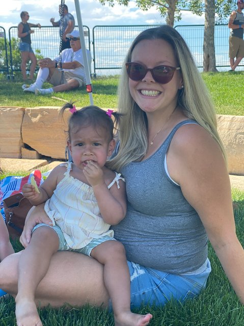 Centennial mom Francesca Sivadhas sat in the shade as she held her 1-year-old daughter, Lakshmi, on July 9, 2022, at Centennial Center Park.