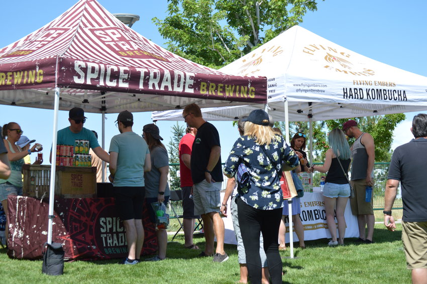 People waiting to get one of their samples of alcohol during Centennial’s annual “Brew-N-Que” event on July 9, 2022, at Centennial Center Park.