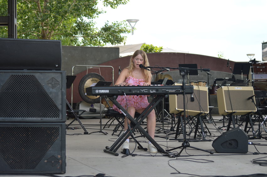 Halley Peecher, a recent graduate of Arapahoe High School, played piano and sang during “The Perfect Playlist” concert at Centennial Center Park on July 31, 2022.
