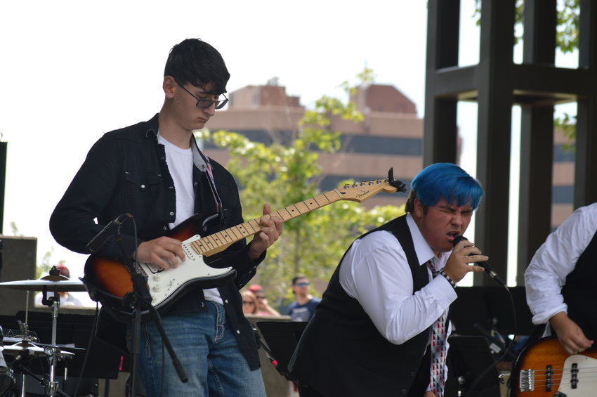 Casey Tibbs, left, and Tristan Shiflett, right, perform during the School of Rock’s setlist at “The Perfect Playlist” concert at Centennial Center Park on July 31, 2022.