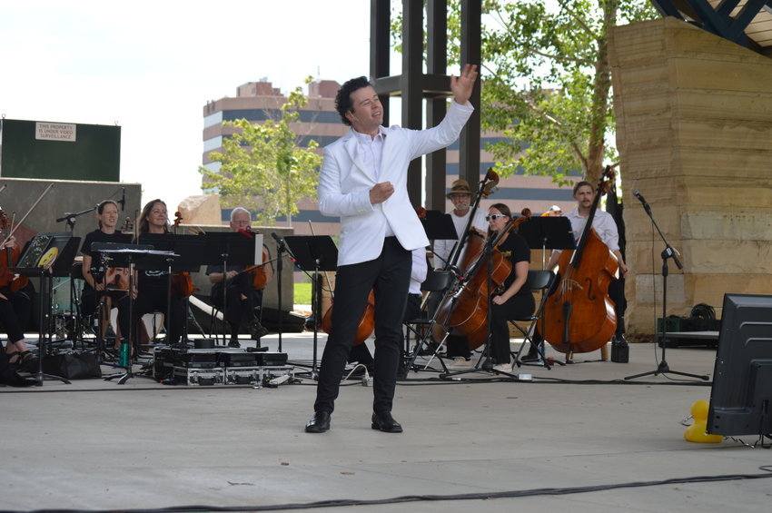 Devin Patrick Hughes, the music director and conductor of the Arapahoe Philharmonic, at “The Perfect Playlist” concert at Centennial Center Park on July 31, 2022.