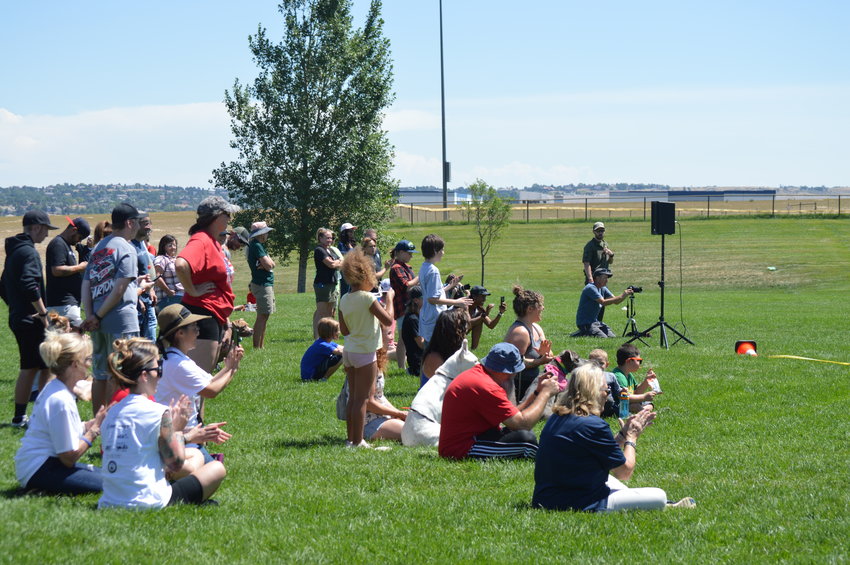People applaud while watching the Arapahoe County Sheriff’s Office bite demonstration on Aug. 6, 2022, at the “RexRun for PAWSitivity” event.
