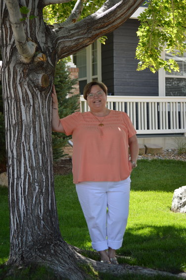 Vanessa Johnston standing beside one of her favorite trees at her home in Highlands Ranch on Aug. 25, 2022.