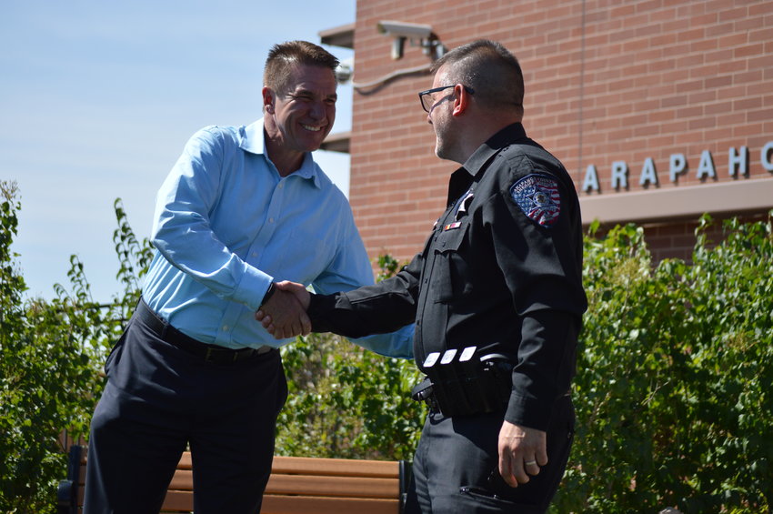 Superintendent Christopher Smith shaking hands with School Resource Officer Deputy Adam Nardi on Sept. 12 during Riley’s swearing-in ceremony.