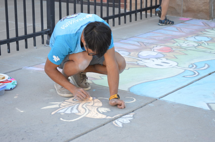 Josh Chow working on the "Pokémon Jubilee" art piece on Sept. 24 at The Streets at SouthGlenn.