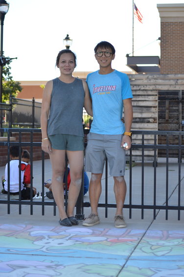Katherine Chow and Josh Chow pose behind the “Pokémon Jubilee” art piece on Sept. 24.