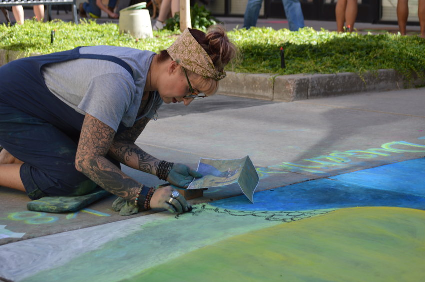 Kari Dusenbery working on her art piece on Sept. 24 at the Centennial Chalk Art Festival at The Streets at SouthGlenn.