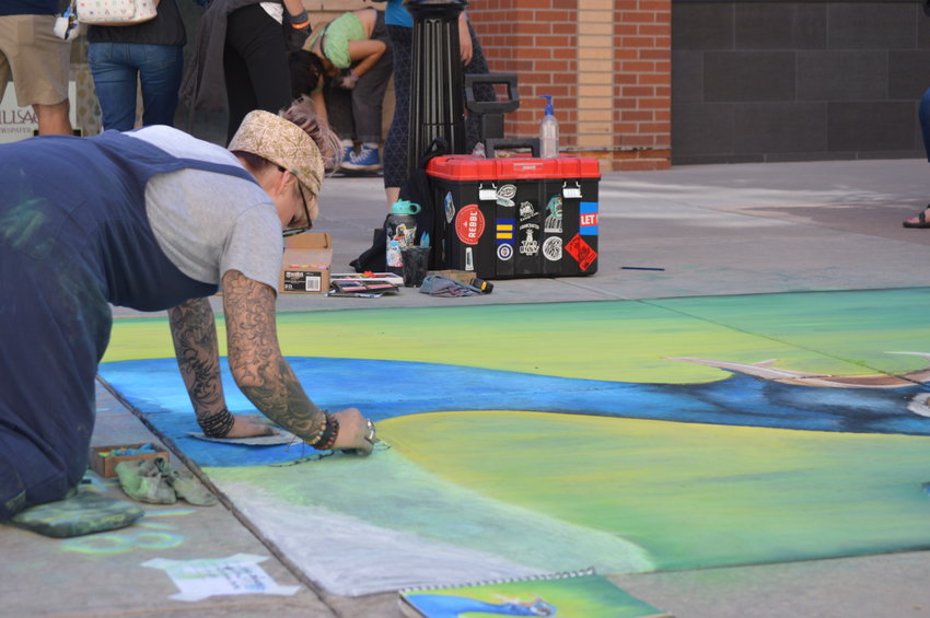 Kari Dusenbery working on her art piece on Sept. 24 at the Centennial Chalk Art Festival at The Streets at SouthGlenn.