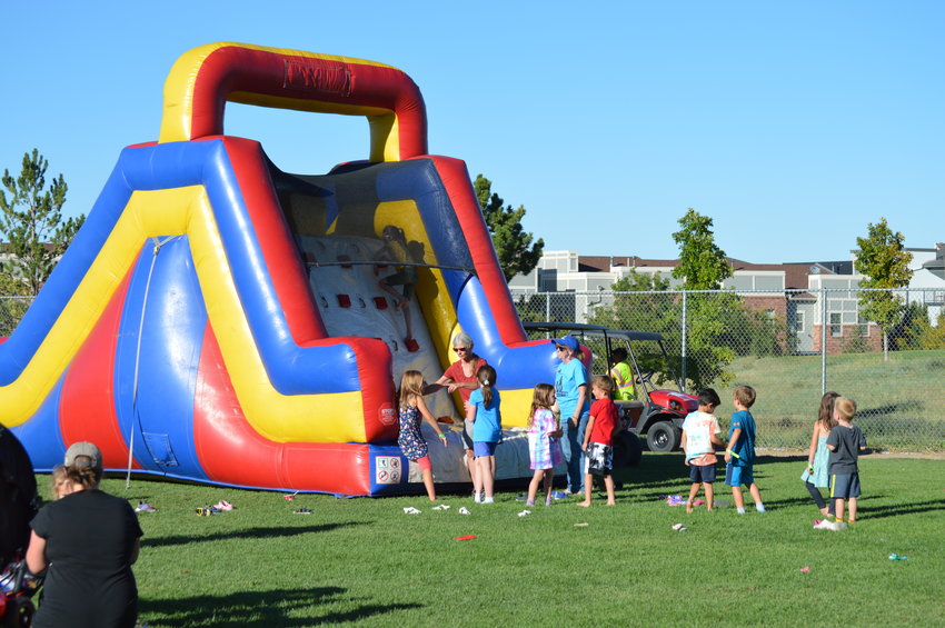 Children lined up to go down the large inflatable slide during the Sept. 24 festival at Prairie Sky Park.