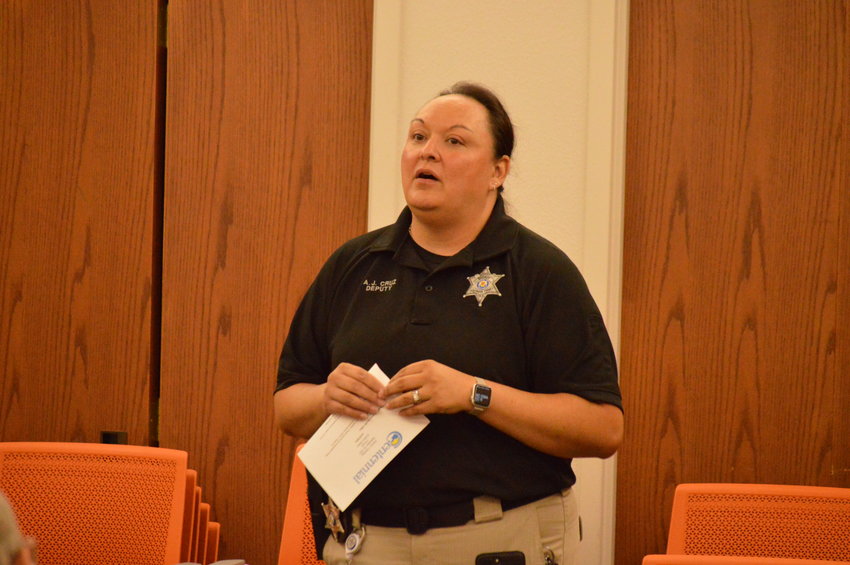 Arapahoe County Sheriff’s Office Deputy Amanda Cruz-Giordano speaking at the Sept. 28 meeting at Koelbel Library.