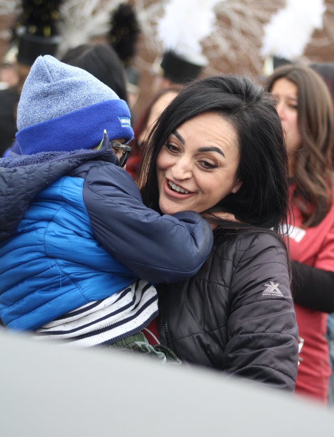 Andrea Hernandez is about to put her bundled-up son, Dorian, into a limousine outside Thimmig Elementary School Nov. 3. It was the first leg of a journey to Tampa Bay, Florida, to see his favorite football team and favorite football player.