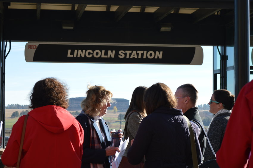 Tour attendees wait for a light rail train at Lincoln Station in Lone Tree on Nov. 9.
