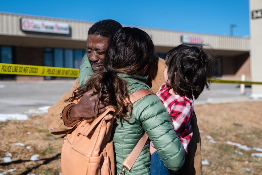 Joshua Thurman, 34, embraces other mourners outside Club Q on Sunday morning. Thurman was at the club when the shooting happened and took shelter in the club’s dressing room with several others.