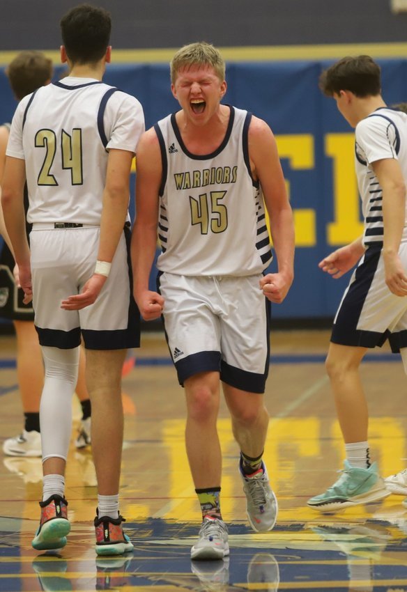 Senior Alex Sturn celebrates after scoring a basket during the Warriors' 67-65 win over No. 11 D'Evelyn.