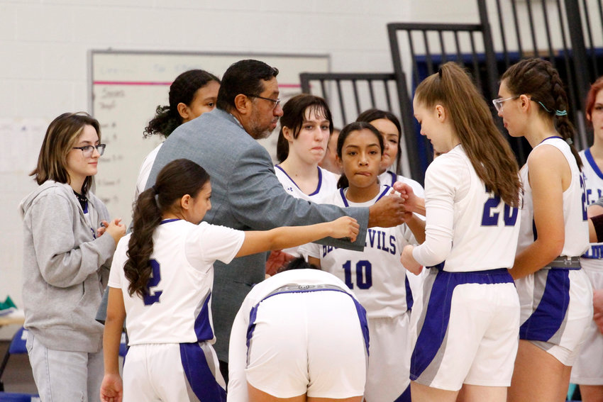 Coach Dan Lira motivates the Bluedevils before they face off against Lincoln High School Dec. 1 in Fort Lupton. This will be the first year as girls' basketball head coach for Lira.