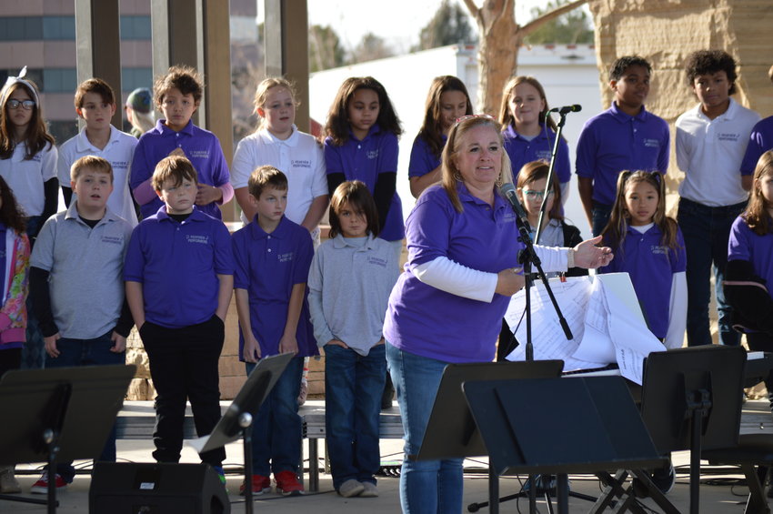 Angela Alderson, a music educator, introduces the Peakview Elementary Choir and Tone Chimes on Dec. 3 at Centennial Center Park.