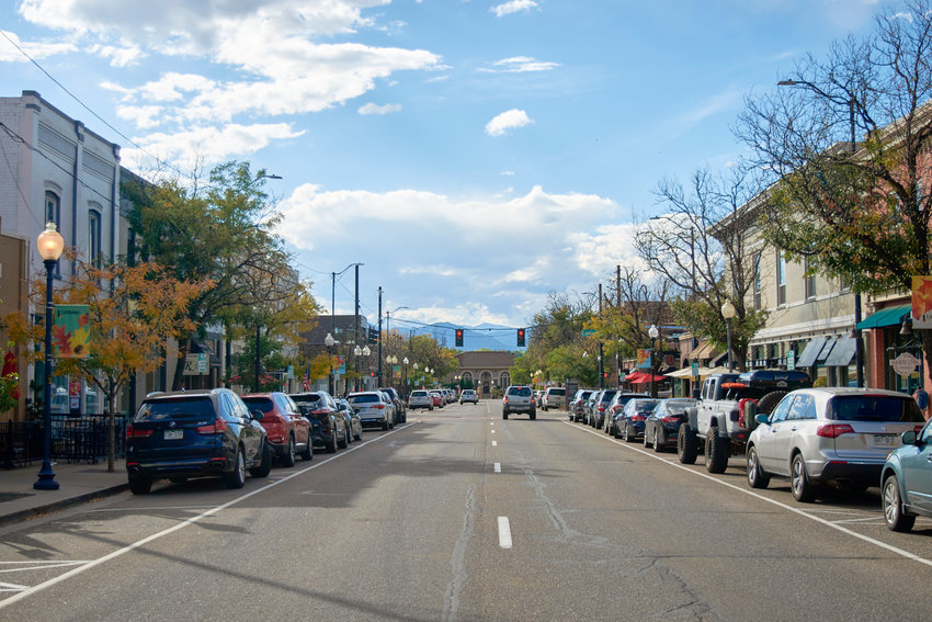 Cars drive down Littleton's Main Street, where Jake's Brew Bar is located.
