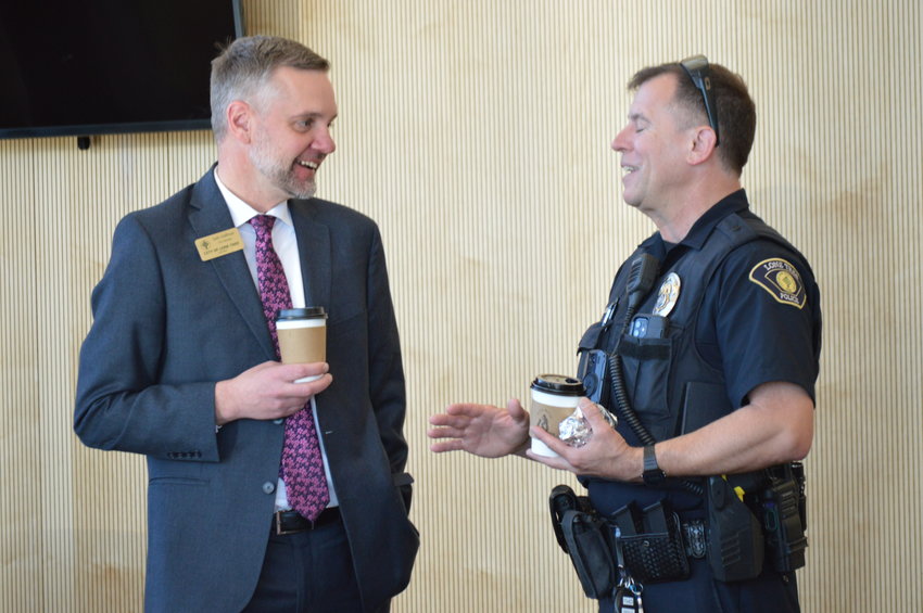 City Manager Seth Hoffman, left, and a Lone Tree police officer speaking after the Feb. 28 State of the City.