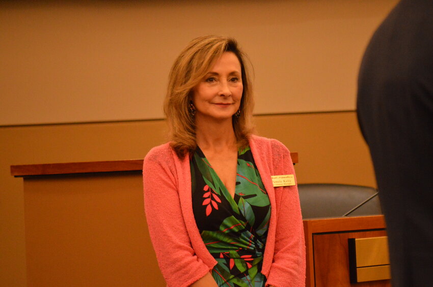 Pamela Schenck-Kelly, Park Meadows’ senior general manager, listening as Lone Tree leaders praised her career on Aug. 1, 2023, in the Lone Tree Civic Center.