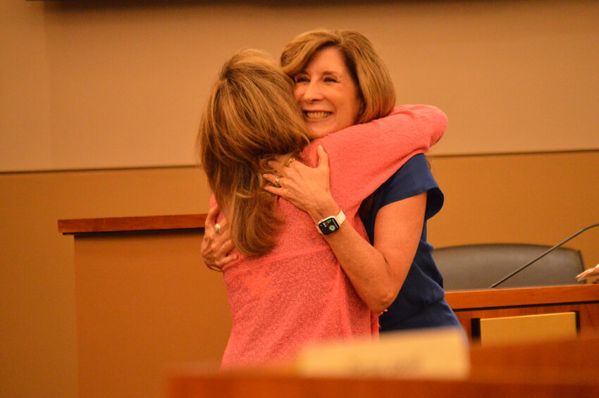 Lone Tree Mayor Jackie Millet hugging Pamela Schenck-Kelly, Park Meadows’ senior general manager, in the Lone Tree Civic Center on Aug. 1, 2023.