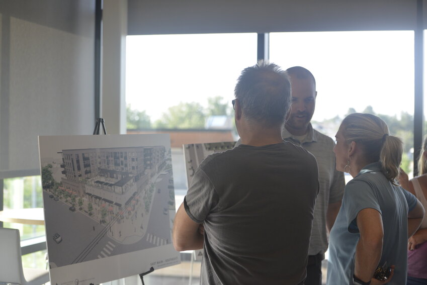 Project Manager for Confluence Companies Dan Tovado speaks to residents about the rendering of the East Main Lot. The lot includes a five-story building, with four residential levels over a commercial level.
