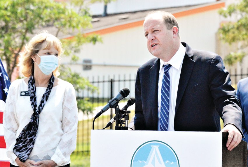 Governor Jared Polis makes a point Aug. 10 while Adams County Commissioner Eva Henry looks on. Polis opened two new free fast-track COVID-19 testing sites Aug. 10, one at the Aurora Sports Complex and a second at Water World in Federal Heights.