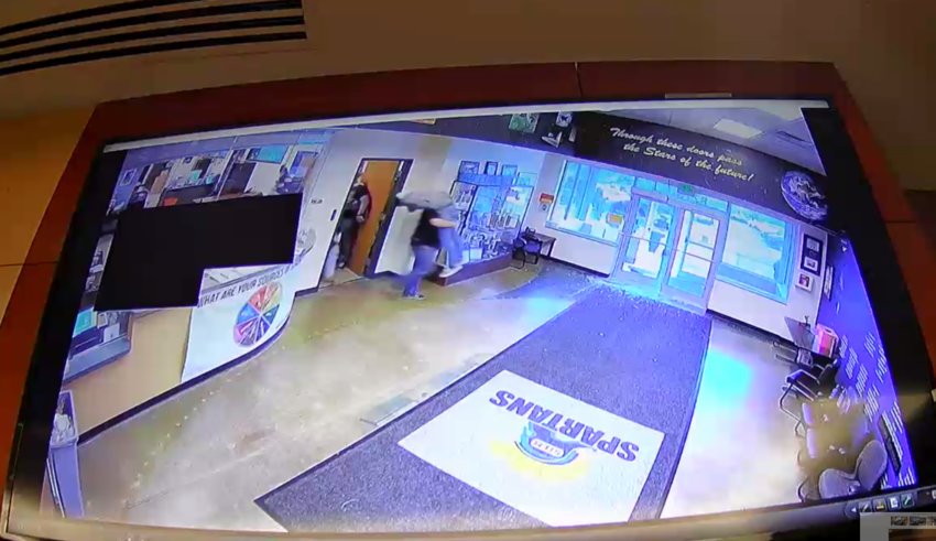 Surveillance footage from inside STEM School Highlands Ranch shows Sgt. Joel White with the Douglas County Sheriff's Office carrying a wounded student out of the school on May 7, 2019. The footage was played during the trial for Devon Erickson, who is facing dozens of charges for his alleged role in the attacks.