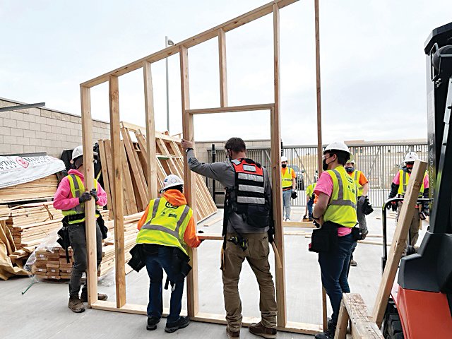 A team at Cherry Creek Innovation Campus works on building tiny homes.