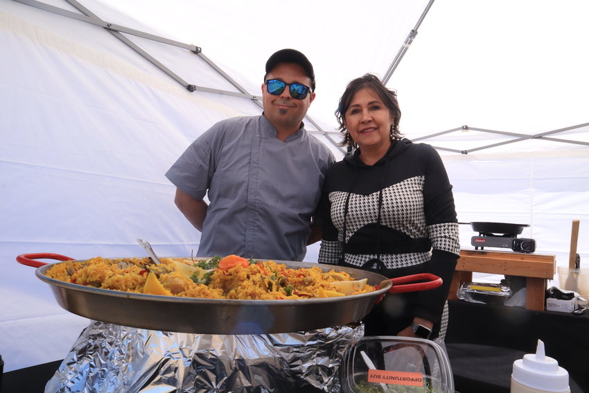 Sebastian Cil and Veronica Hanalwalt present their homemade paella during the first day of the Southwest Plaza farmers market April 30. The day also marked Cil and Hanalwalt's market debut.