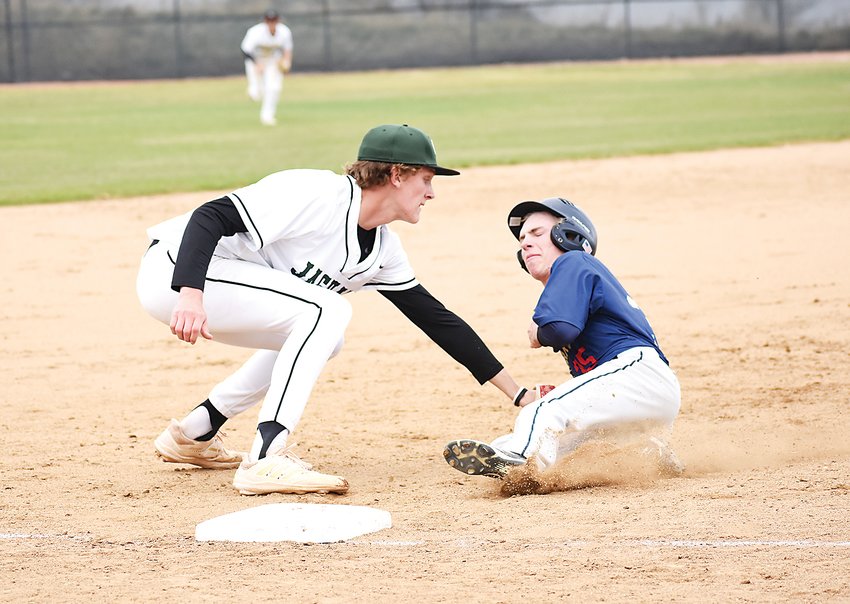 D&rsquo;Evelyn senior Troy Benko, left, tags out Evergreen junior Stephen Hartmere at third base during the third inning May 3 at D&rsquo;Evelyn Junior/Senior High School. The Jaguars won 7-0.