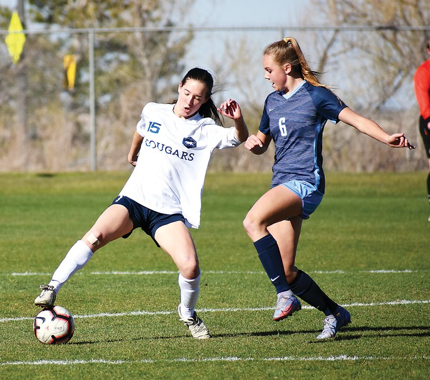 Evergreen senior Elizabeth Rapp, left, battles with Ralston Valley freshman Holly Engelking (6) during the finale regular-season game May 5 for the Cougars and Mustangs before the postseason. The game ended in a scoreless overtime draw.
