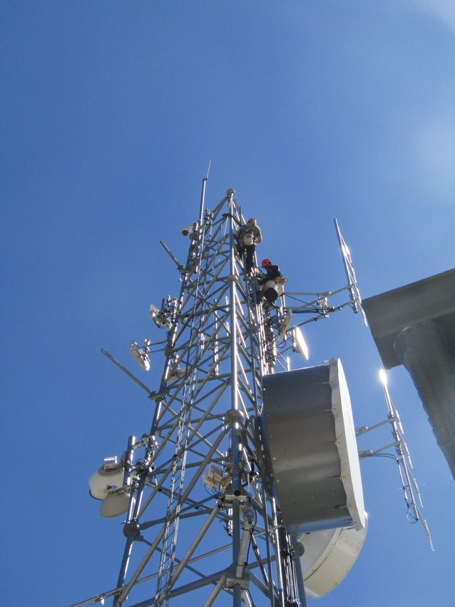 Technicians install an infrared camera at the top of a tower at Elk Creek Fire Station 3 on Conifer Mountain. The camera will be monitored 24/7 to look for signs of smoke and wildfire.