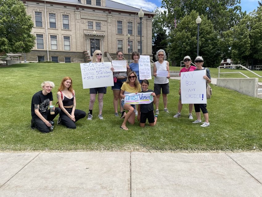 Protesters stand outside the Littleton court house June 24.
