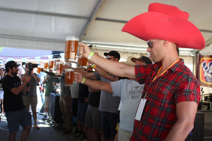 John Maslowsky, right, and others participate in the beer-stein-holding competition during the inaugural Wild West Oktoberfest Sept. 24 in downtown Golden. Maslowsky was volunteering at the event for YoColorado, the organizer.