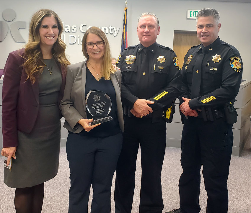 Douglas County School District's Superintendent Erin Kane, left, and Director of Mental Health Stephanie Crawford-Goetz pose will Douglas County Sheriff's Office Lt. Rob Rotherham and sheriff-elect Darren Weekly on Nov. 15 at the district administration building. Crawford-Goetz received the 2022 Ron King Service Award from the sheriff's office for her work to support homeless youth and promote student mental health.